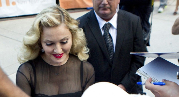 Director Madonna pauses to sign autographs at the premiere of her film "W.E." at the TIFF