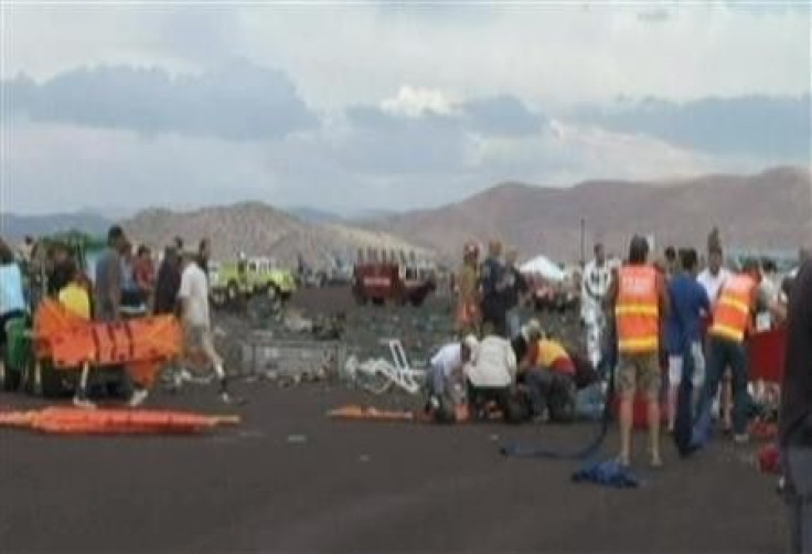 First responders and people help victims in this image taken from a video after a vintage World War Two fighter plane crashed near the grandstand at the Reno Air Races in Reno, Nevada
