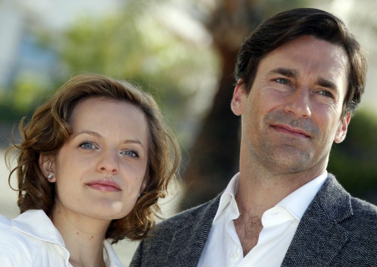 Cast members Moss and Hamm pose during a photocall to promote their television series &quot;Mad Men&quot; at the annual MIPCOM television programme market in Cannes