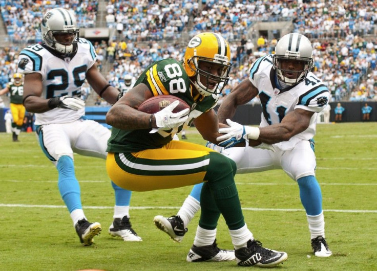 Green Bay Packers tight end Jermichael Finley catches a pass in the endzone against Carolina Panthers cornerback Captain Munnerlyn during NFL football game in Charlotte