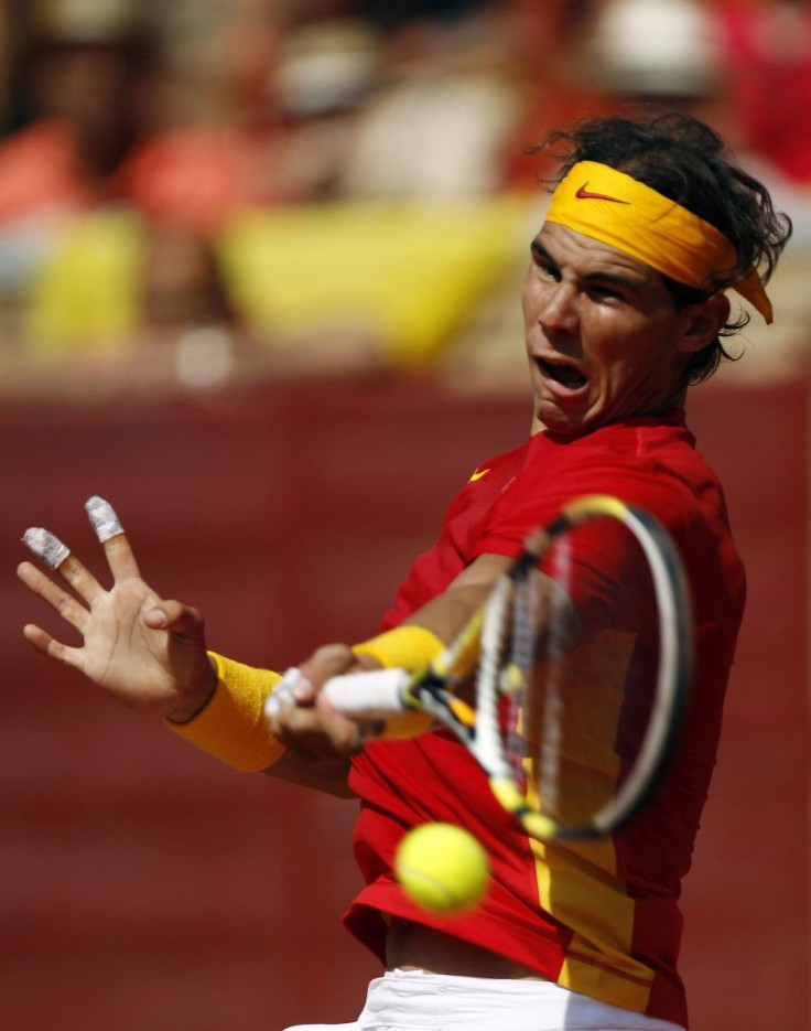 Nadal of Spain returns a shot to Tsonga of France during their Davis Cup World Group semi-final match at Cordoba bullring