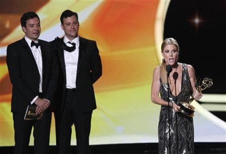 Actress Julie Bowen from television series ''Modern Family'' accepts the award for Outstanding Supporting Actress in a Comedy Series as presenters Jimmy Kimmel (L) and Jimmy Fallon look on, at the 63rd Primetime Emmy Awards in Los Ange