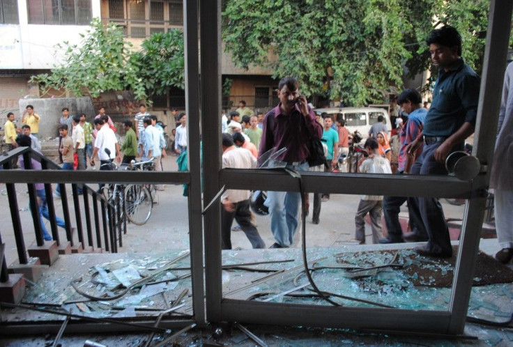Onlookers stand at the site of a blast in Agra