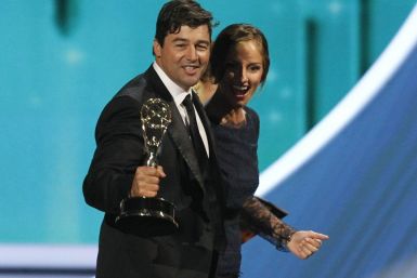 Actor Kyle Chandler walks offstage with presenter Minka Kelly after accepting outstanding lead actor in a drama series for &quot;Friday Night Lights&quot; at the 63rd Primetime Emmy Awards in Los Angeles