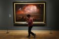 A worker at the Tate Britain walks past John Martin&#039;s recently restored &quot;The Destruction of Pompeii and Hercuaneum&quot;, as retouches paintwork on the walls, in central London