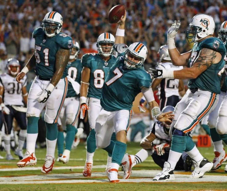 Dolphins quarterback Henne celebrates after running the ball into the endzone for a touchdown against the Patriots in Miam