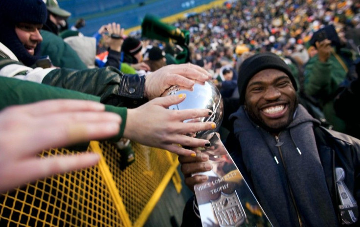 NFL Super Bowl Champions Green Bay Packers&#039; Nick Collins carries the Super Bowl Trophy on a victory lap during the &quot;Return To TitleTown Celebration&quot; at Lambeau Field