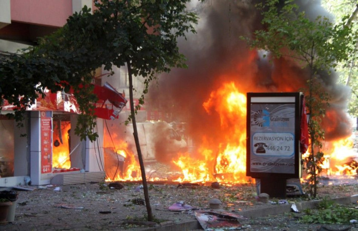 Flames are seen in a street after a blast in central Ankara