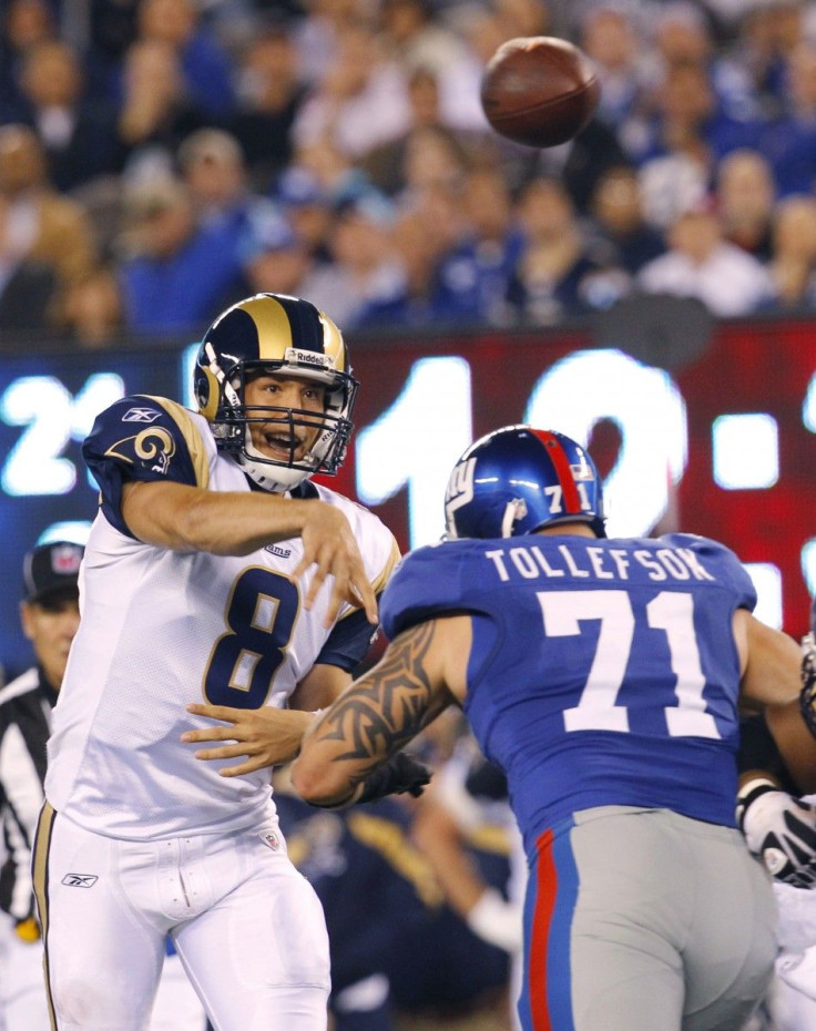 St. Louis Rams' Bradford throws the ball over New York Giants' Tollefson during their NFL football game in East Rutherford