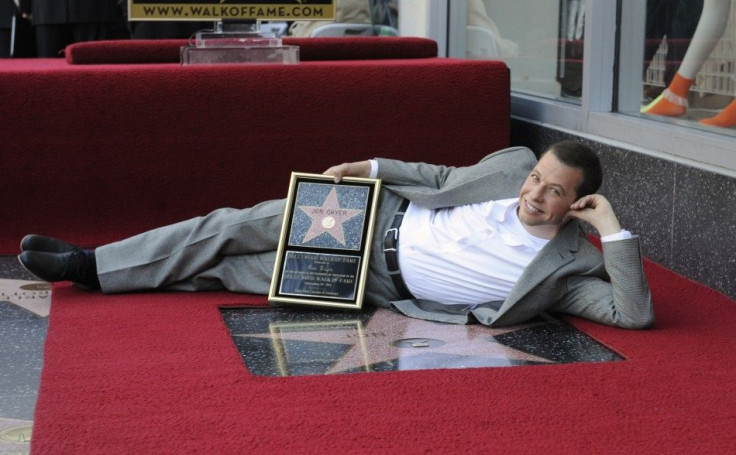 Jon Cryer poses for photographers with his commemorative plaque during a ceremony honoring him with a star on the Hollywood Walk of Fame in Los Angeles