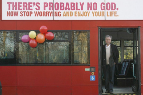 British author Richard Dawkins stands on a bus at the launch of an atheist advertising campaign in London