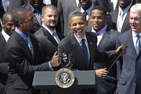 U.S. President Obama laughs with Charles Woodson as he honours the Green Bay Packers at the White House in Washington