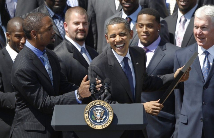 U.S. President Obama laughs with Charles Woodson as he honours the Green Bay Packers at the White House in Washington
