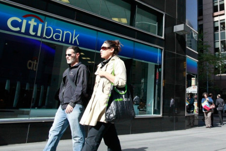 Pedestrians walk outside a bank