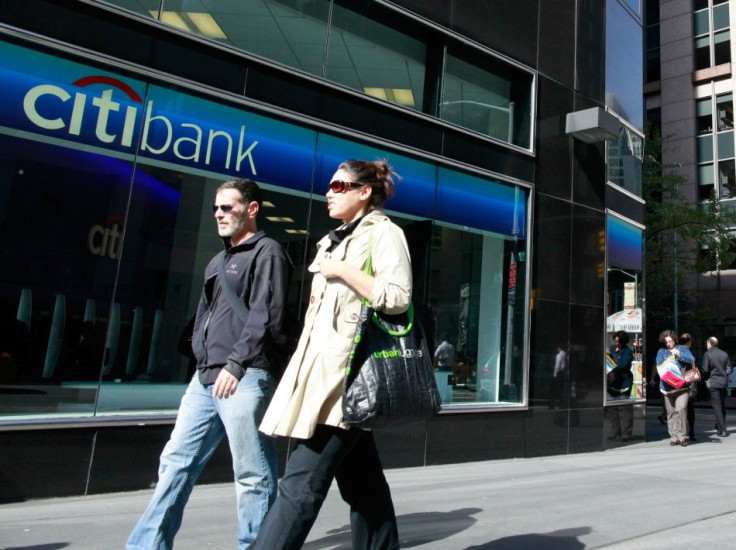 Pedestrians walk outside a bank