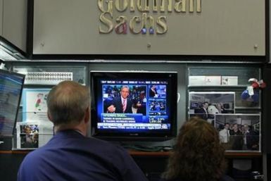 Traders work in the Goldman Sachs stall on the floor of the New York Stock Exchange