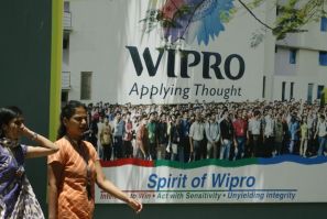 People walk in the Wipro campus in Bangalore June 23, 2009. Goldman Sachs counts the lack of quality education as one of the 10 factors holding India back from rapid economic growth.