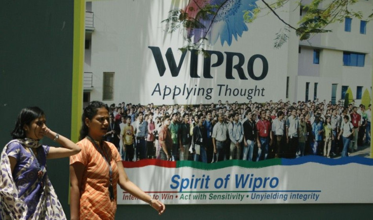 People walk in the Wipro campus in Bangalore June 23, 2009. Goldman Sachs counts the lack of quality education as one of the 10 factors holding India back from rapid economic growth.