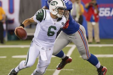 New York Jets Mark Sanchez breaks away from New York Giants Justin Tuck in East Rutherford