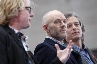 The band R.E.M. with Mike Mills (L) who plays bass guitar, lead singer Michael Stipe (C) and Peter Buck, who plays guitar, are interviewed on the plaza of Rockefeller Center during the Today Show in New York