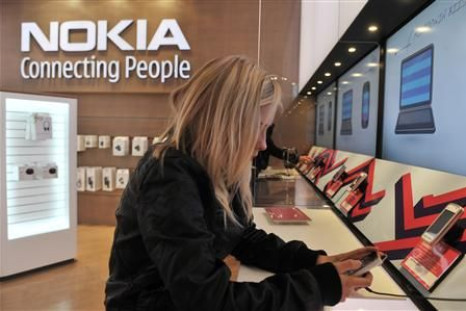 A girl tests out the new Nokia N8 mobile phone at the Nokia Flagship store in Helsinki