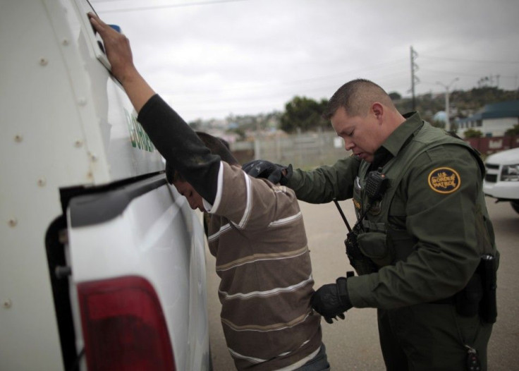 A United States border patrol agent catches an illegal immigrant crossing from Mexico to the U.S. in San Ysidro