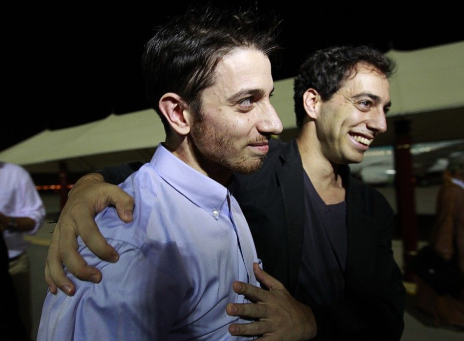 Josh Fattal, one of the U.S. hikers who was held in Iran on charges of espionage, hugs his brother Alex upon his arrival in Muscat after the release from Tehrans Evin prison