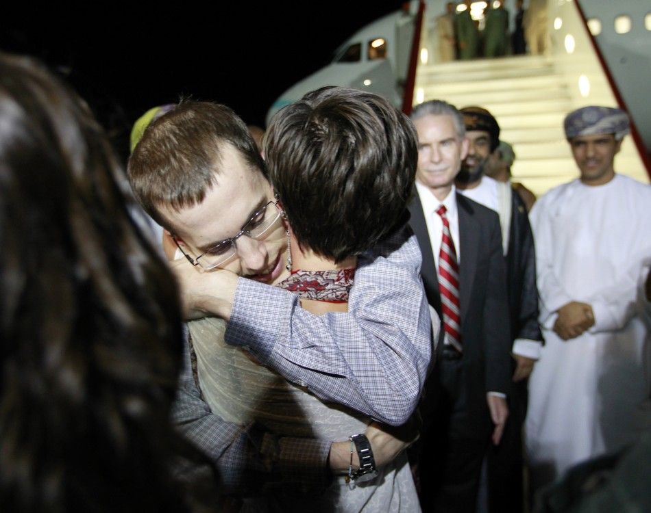 Shane Bauer, one of the U.S. hikers who was held in Iran on charges of espionage, hugs fiance Sarah Shourd during his arrival in Muscat after his release from Tehrans Evin prison
