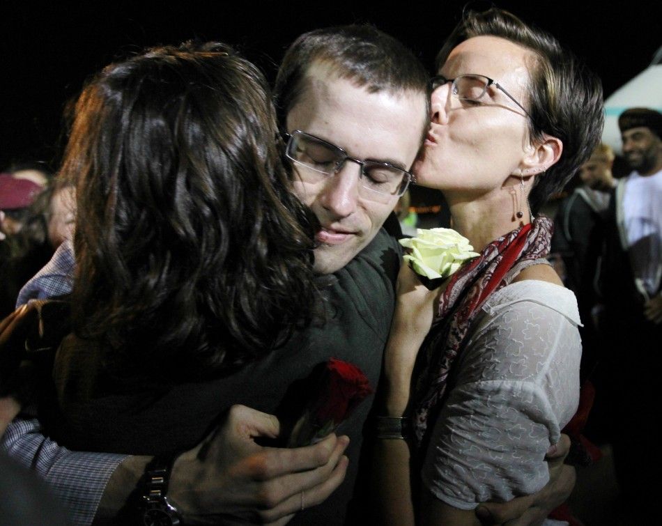 Shane Bauer, one of the U.S. hikers who was held in Iran on charges of espionage, hugs fiance Sarah Shourd during his arrival in Muscat after his release from Tehrans Evin prison