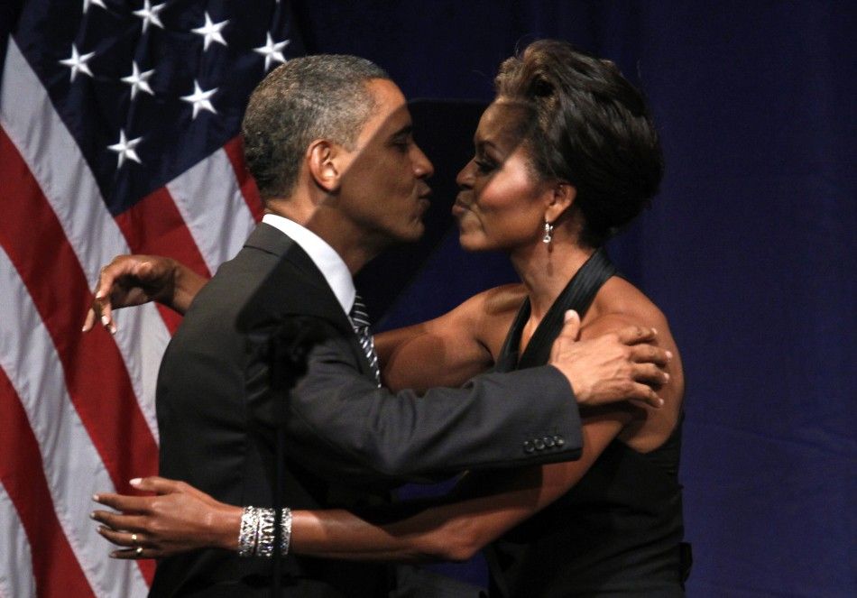 U.S. President Barack Obama kisses first lady Michelle Obama after she introduced him to speak at a fund raiser in New York September 20, 2011
