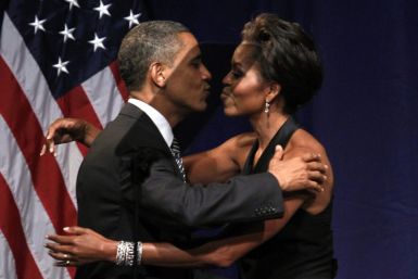 U.S. President Barack Obama kisses first lady Michelle Obama after she introduced him to speak at a fund raiser in New York September 20, 2011