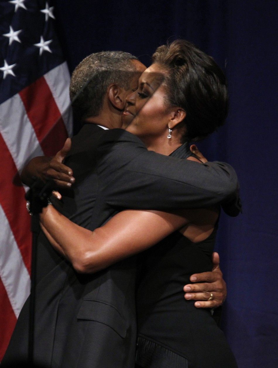 U.S. President Barack Obama embraces first lady Michelle Obama after she introduced him to speak at a fund raiser in New York September 20, 2011.
