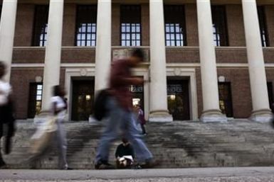 A students sits on the steps of Widener Library at Harvard University in Cambridge