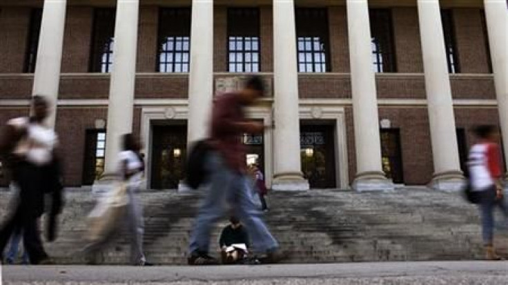 A students sits on the steps of Widener Library at Harvard University in Cambridge