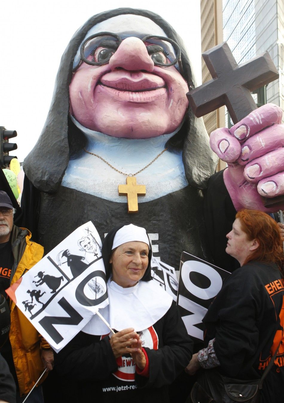 Demonstrators opposing the visit of Pope Benedict XVI dress as Catholic nuns during a protest at Potsdamer Platz in Berlin