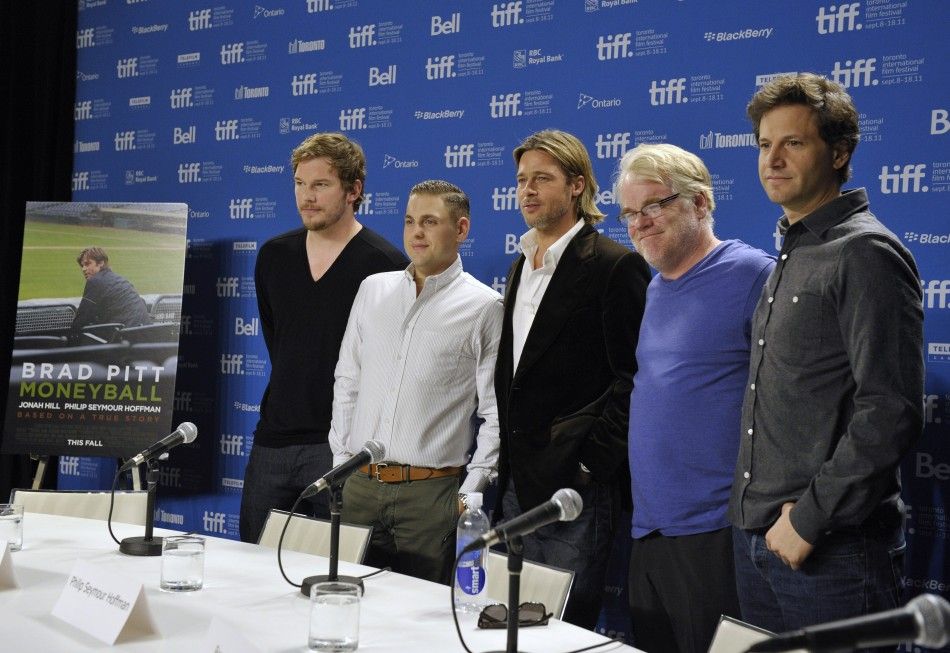 Cast members pose at the news conference for the film Moneyball at the Toronto International Film Festival