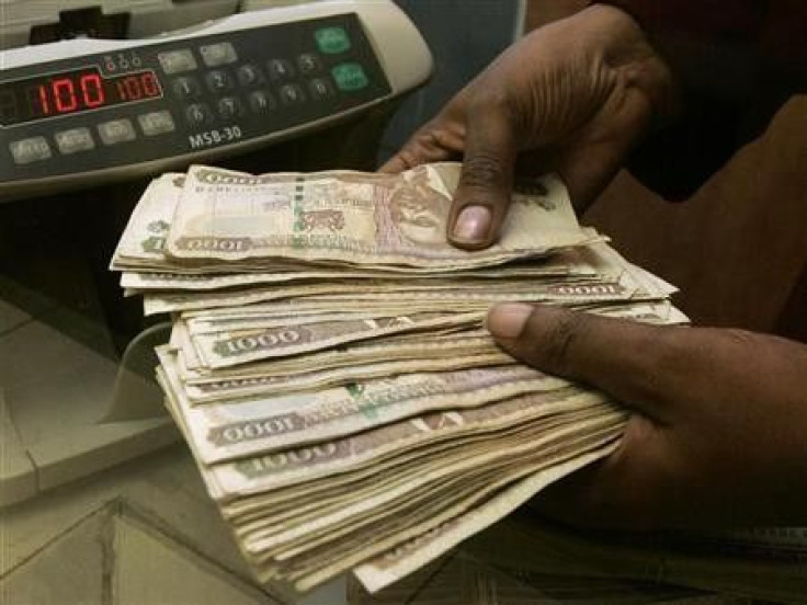 A currency dealer counts Kenya shillings at a money exchange counter in Nairobi 