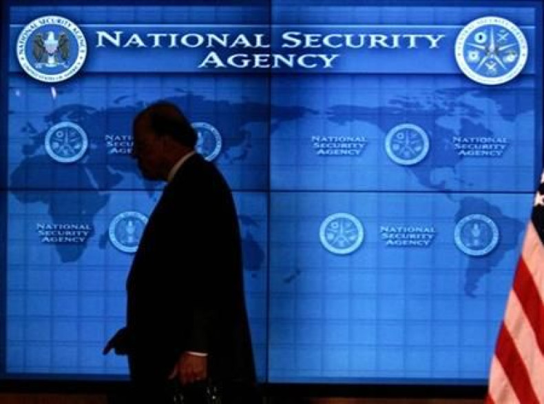 National Intelligence Director John Negroponte past a video screen at National Security Agency at Fort Meade