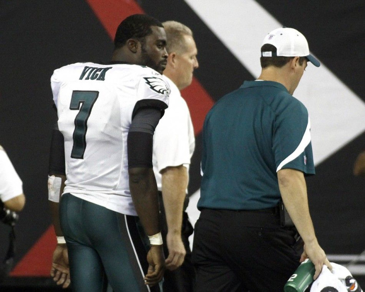 Eagles quarterback Vick leaves the field after running into one of his teammates during their NFL football game against the Atlanta Falcons in Atlanta.