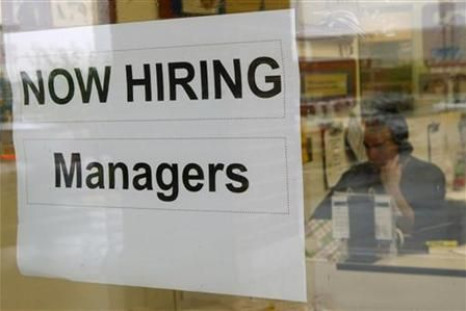 A hiring sign hangs in a window in Virginia