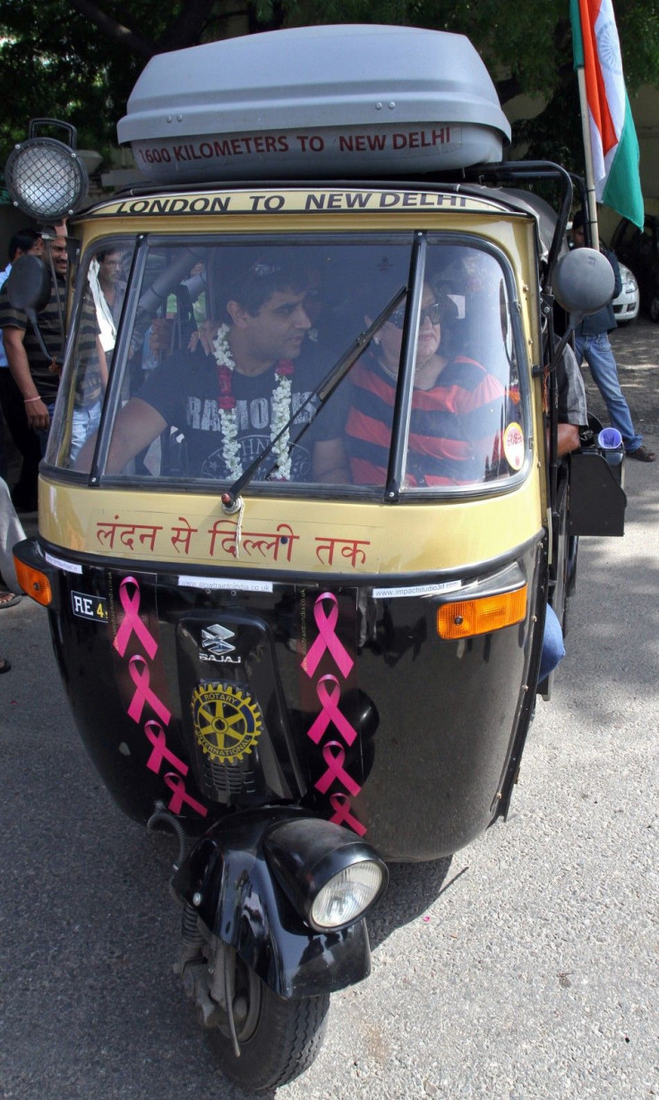 Sharma drives &quot;Flying Rani,&quot; a black-and-yellow auto rickshaw with a 175 cc engine, through a street in New Delhi