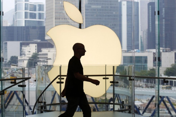 An employee walks inside Hong Kong&#039;s first Apple Store at Two IFC before its opening in the financial Central district