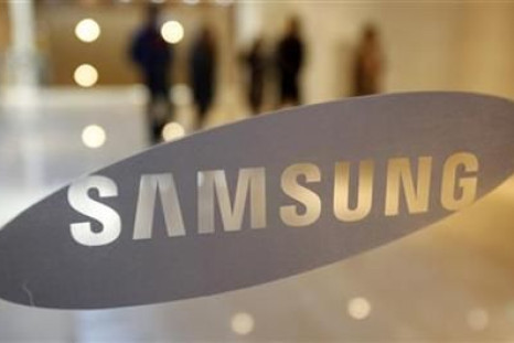 Visitors walk behind a logo of Samsung Electronics in Seoul
