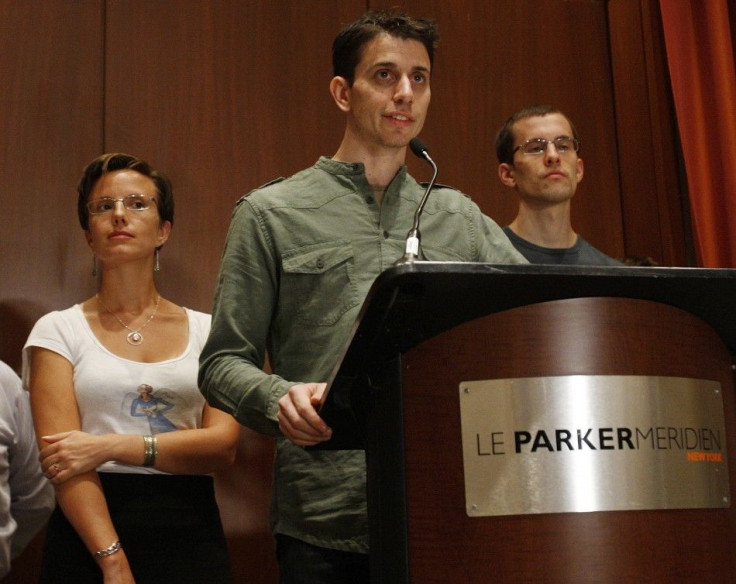 Sarah Shourd looks up at Josh Fattal as he delivers a statement about his release from detention in Iran with Shane Bauer at a news conference in New York September 25, 2011