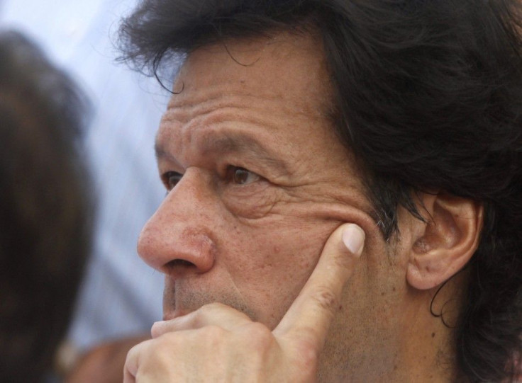 Khan, Pakistani cricketer turned politician, is photographed on stage before leading a Tehreek-e-Insaf rally against drone attacks in Karachi