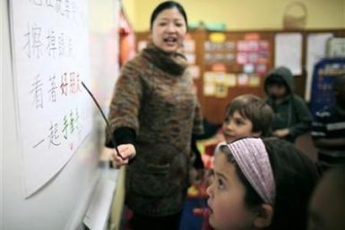 Teacher Kennis Wong points to Chinese characters on the board at Broadway Elementary School in Venice, Los Angeles