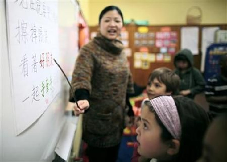 Teacher Kennis Wong points to Chinese characters on the board at Broadway Elementary School in Venice, Los Angeles