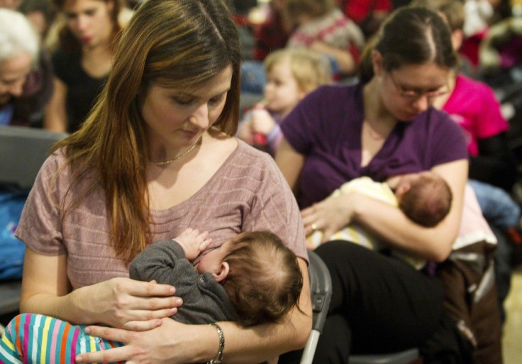 Mothers participate in a demonstration in front of a clothing store in a shopping mall in Montreal