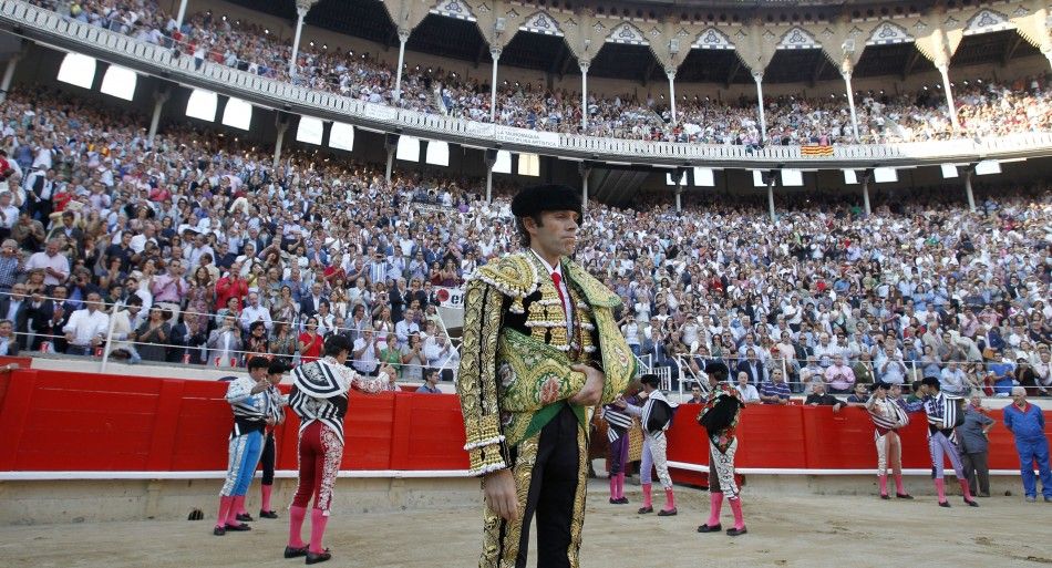 Spanish bullfighter Jose Tomas walks into the arena