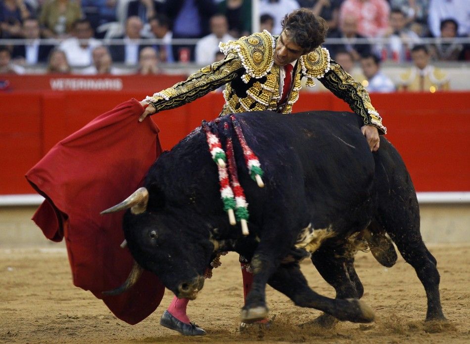 Spanish bullfighter Jose Tomas performs a pass